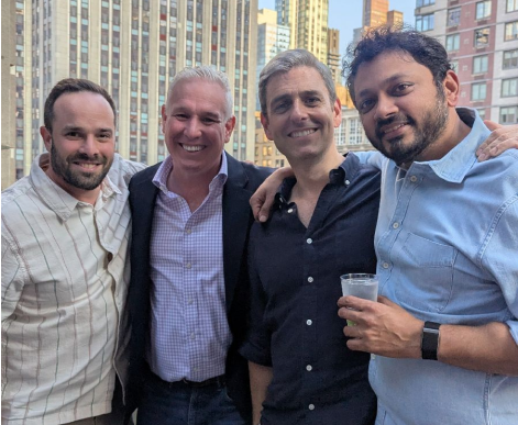 Media.net executives posing with a client at an NYC rooftop party.